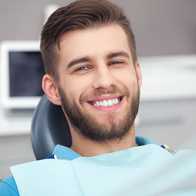Man in dental chair smiling with dental implants in Reynoldsburg, OH
