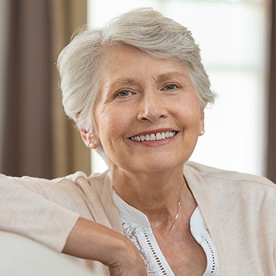 woman sitting on couch smiling