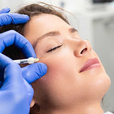 woman getting botox by eye