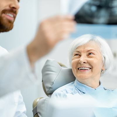 dentist showing x-ray to patient