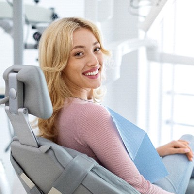 Blonde female patient smiling in dental chair