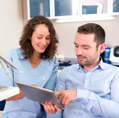 Dentist and patient discussing the cost of dental emergencies in Reynoldsburg