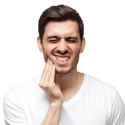 Man with tooth pain, may be experiencing dental implant failure