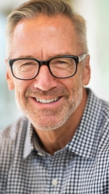 man with glasses on smiling